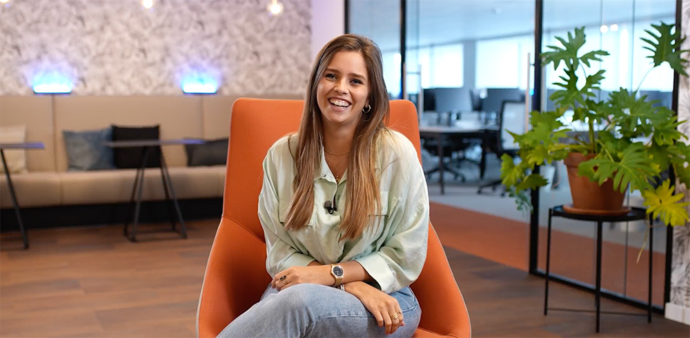Our experts - video Meet Naomi, photo of him sitting down in front of the camera.