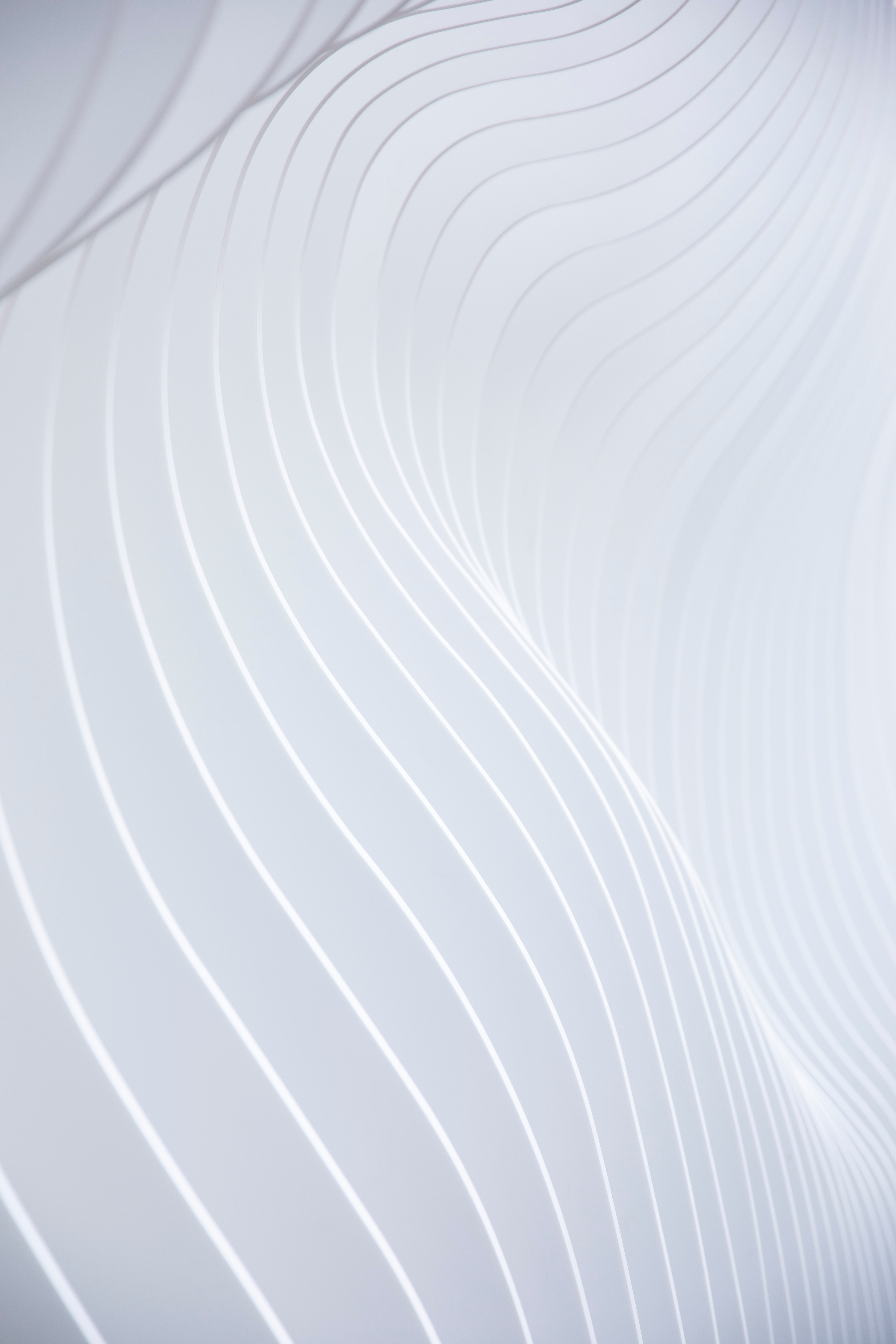 A clean white wall with faint linear markings running across it, creating a subtle pattern of simple lines on an otherwise plain surface.