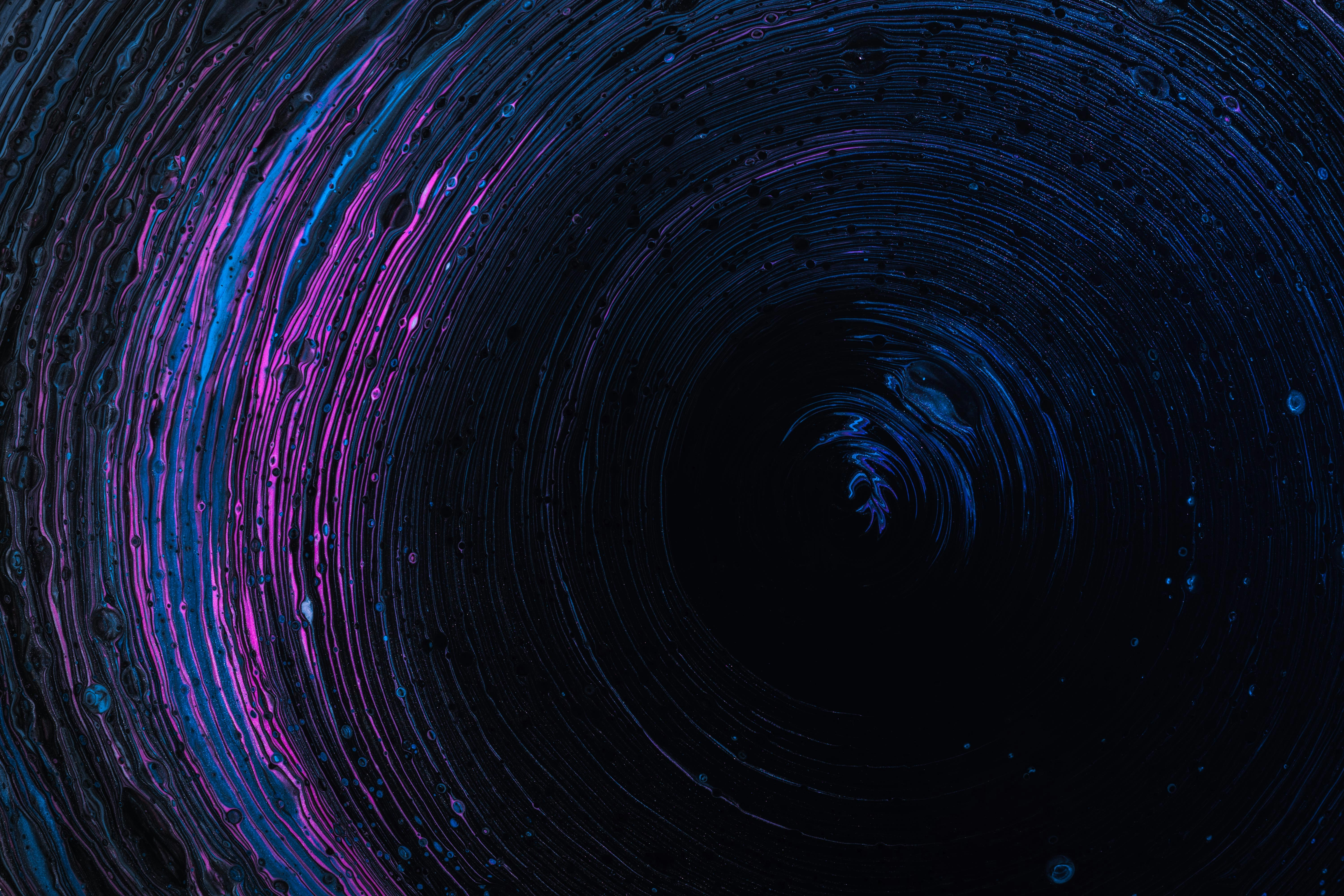 Dark background with waves creating a circular motion