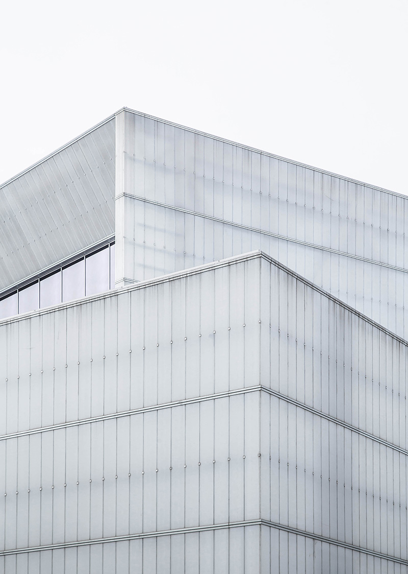 Stockimage with a greytoned overlay of a building against a white sky.